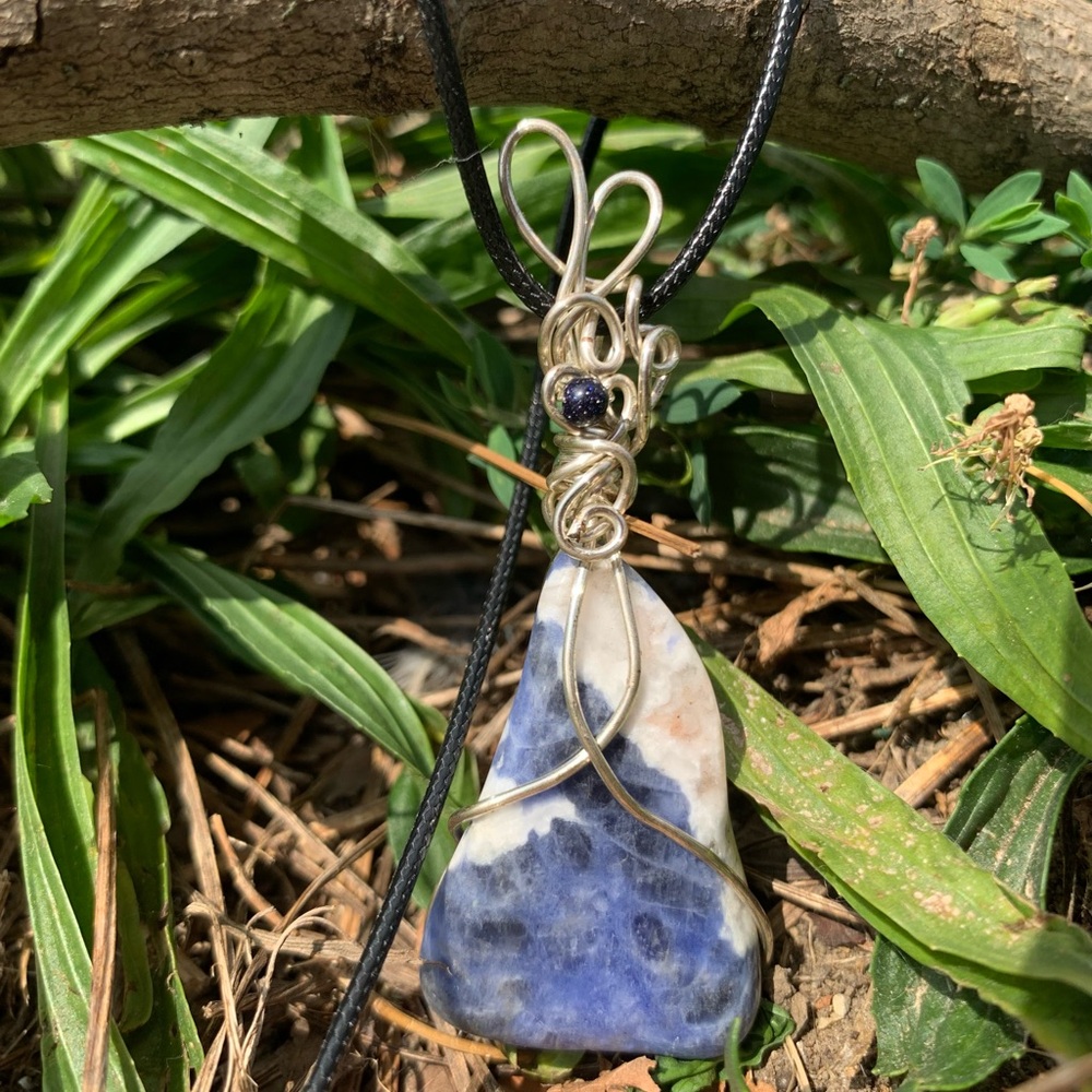 Sodalite gemstone with blue goldstone accent.